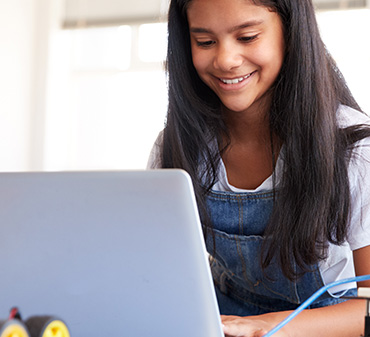 young girl facing computer