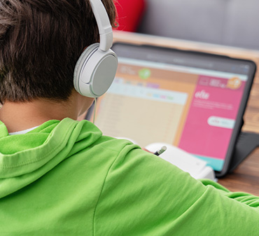 boy with headphones on surface pro